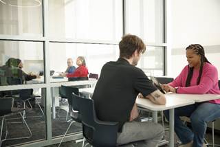 people study at desks in different rooms